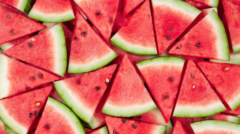 Overhead view of watermelon slices with black and white seeds
