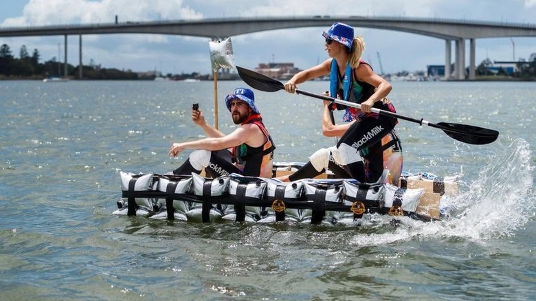 Three people on a goon raft