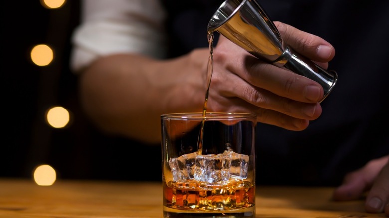 Pouring bourbon into a glass 