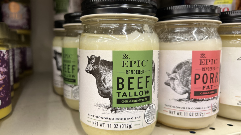 jars of beef tallow and rendered pork fat on a grocery store shelf