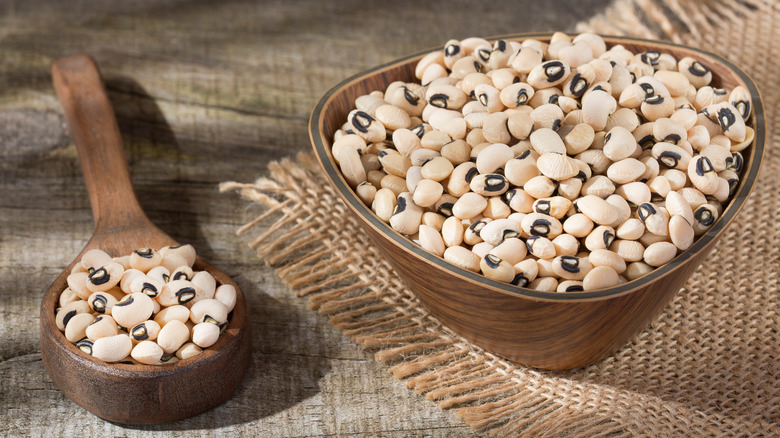 Bowl of black-eyed peas next to wooden spoon