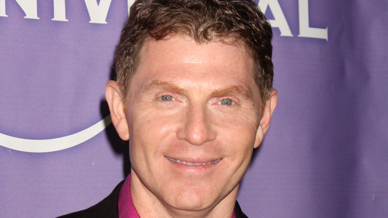 Bobby Flay in pink shirt and black jacket