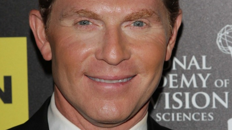 Bobby Flay smiling on the red carpet