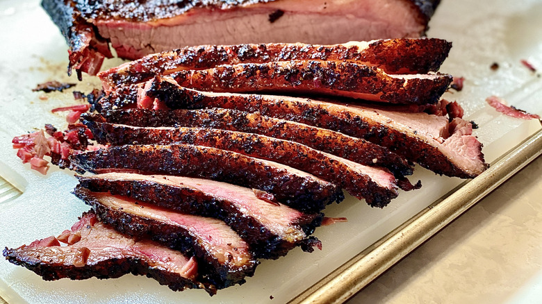 Sliced brisket on cutting board.