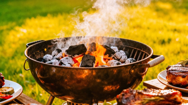 Charcoal burning inside open grill.