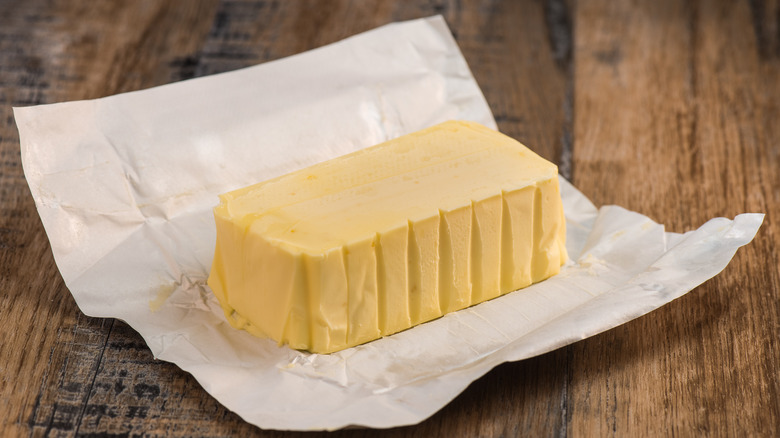 Block of butter in paper