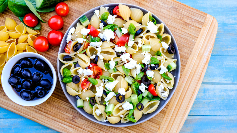 Pasta salad with olives, tomatoes, cheese, and herbs