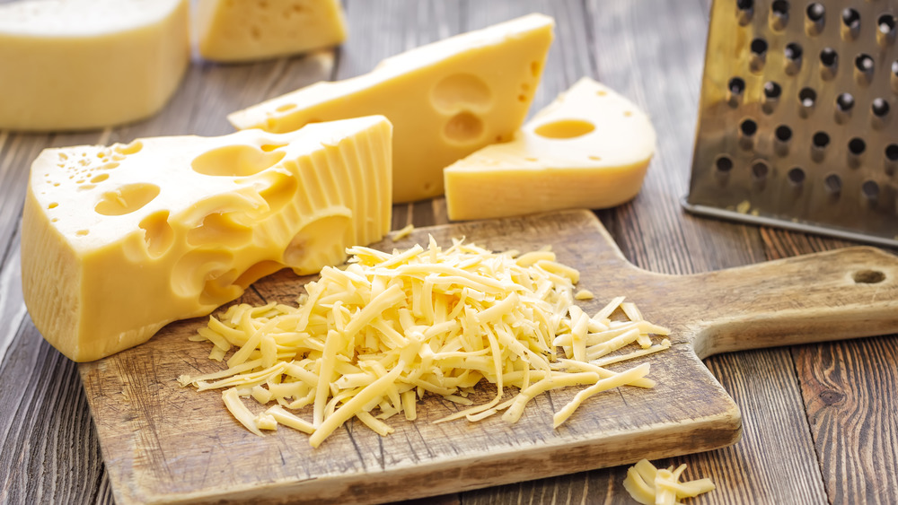 Swiss cheese on cutting board, grated 