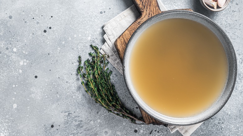 chicken stock next to herbs