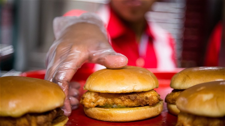 Chick-fil-A worker reaches for sandwich