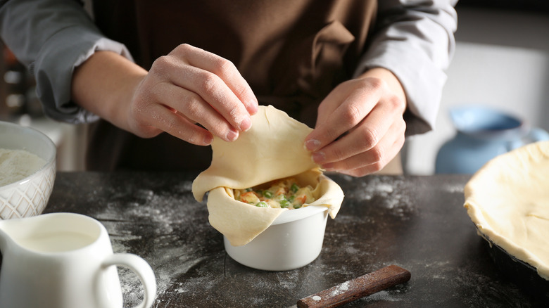 Person making chicken pot pie