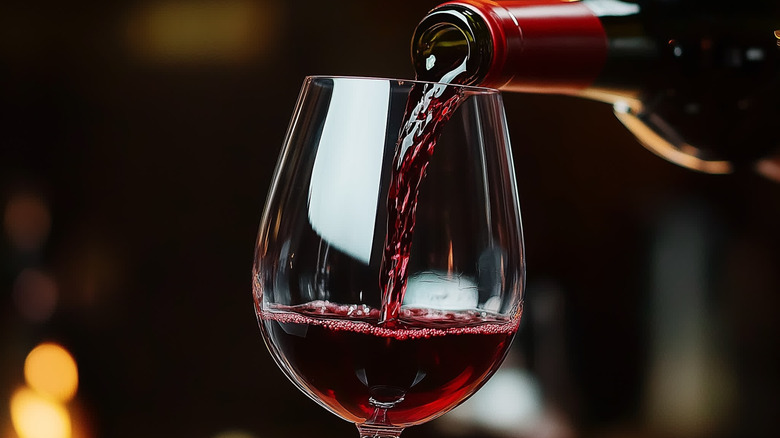 Red wine being poured at restaurant