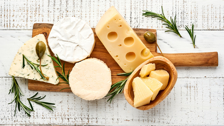 various cheeses on wood board