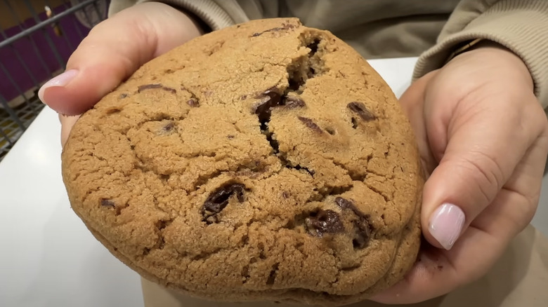 Hands holding warm costco cookie