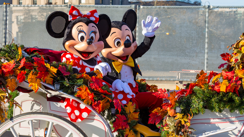 Mickey and Minnie Mouse in open carriage