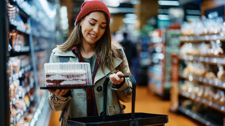 woman holding grocery store cake