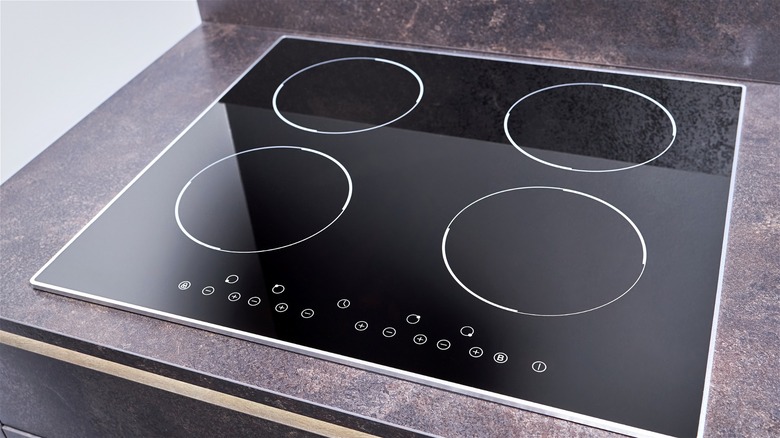 An induction cooktop installed on a granite kitchen counter.
