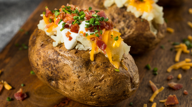 Loaded baked potato on cutting board