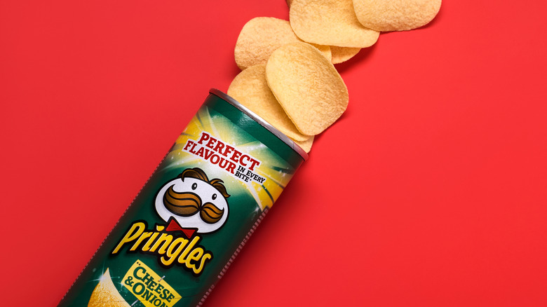 Opened Pringles tube on red background