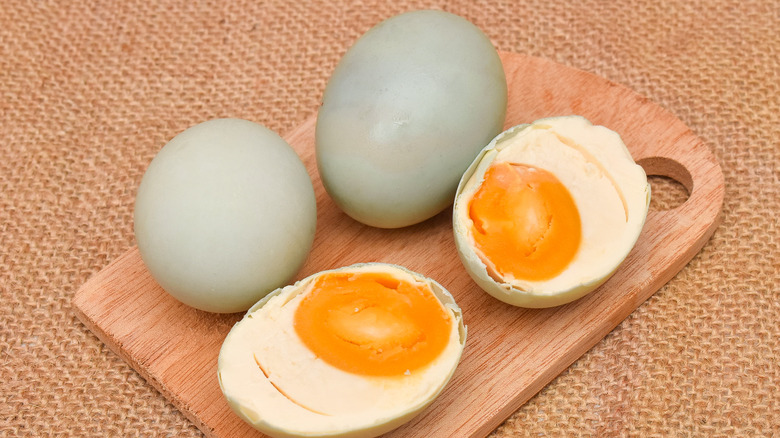 Salted duck eggs on a wood board