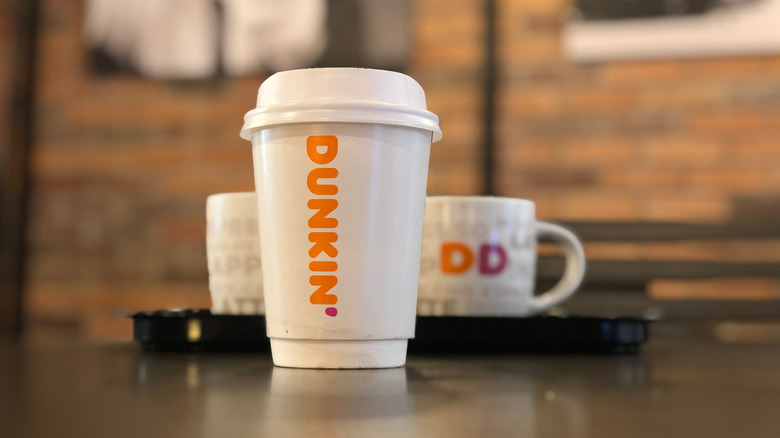 Dunkin coffee cups on a table