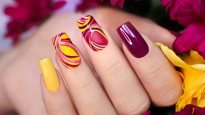 Long acrylic nails painted with Dunkin' color scheme