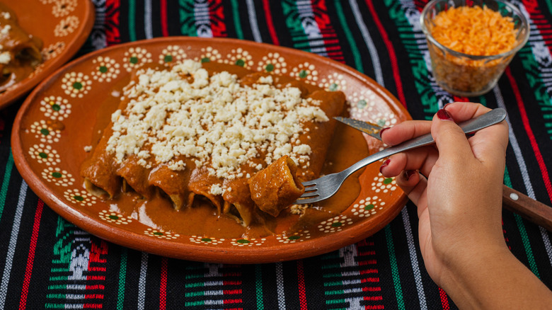 person eating enchiladas