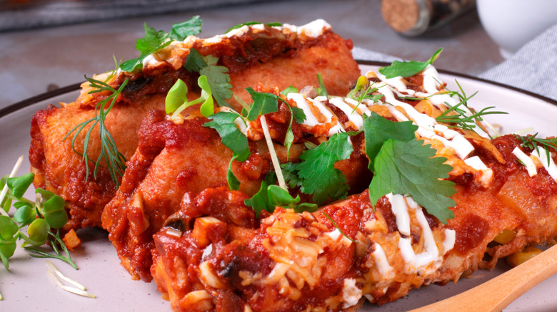 enchiladas covered in crema and herbs