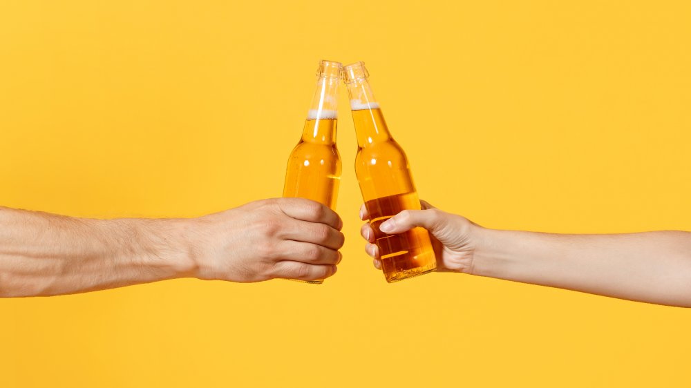two people with beer bottles