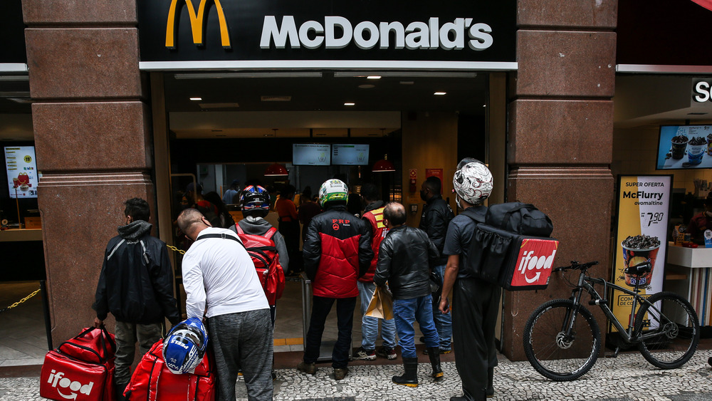 McDonald's storefront with a crowd waiting to get in