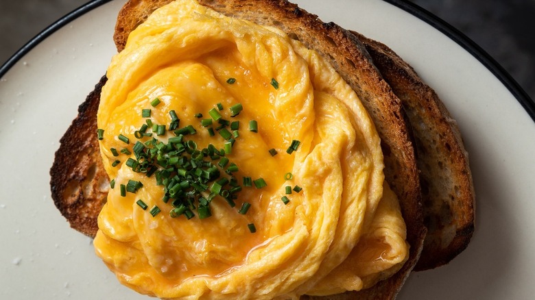 Soft scrambled eggs served on a white plate 