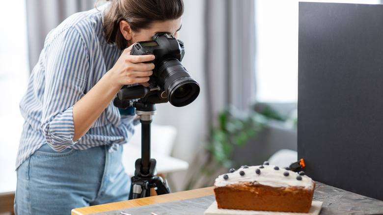 Woman photographing a cake