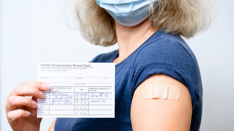 Woman with vaccine card