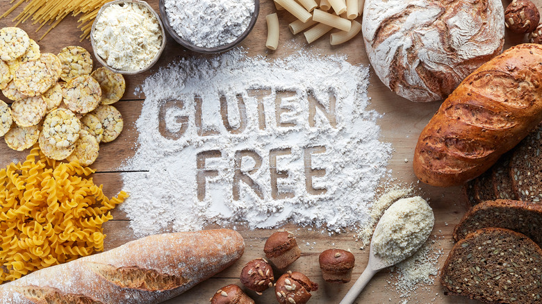 Breads and pastas arranged around the words 'gluten free' written in flour