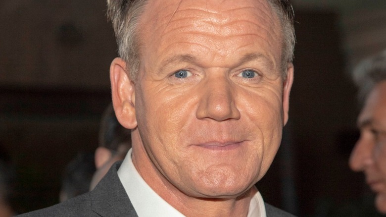 Gordon Ramsay smiles in gray suit