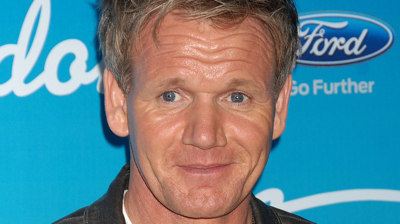 Gordon Ramsay smiles in a white T-shirt and black button-up