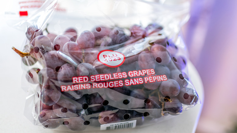 Red seedless grapes in a plastic bag with holes