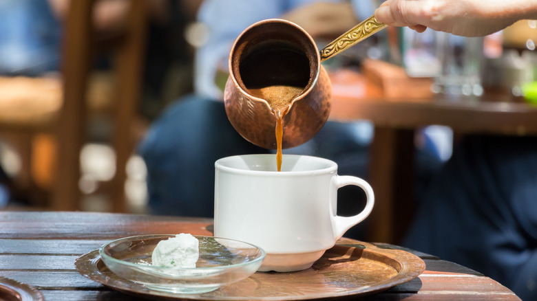 pouring Greek coffee into cup