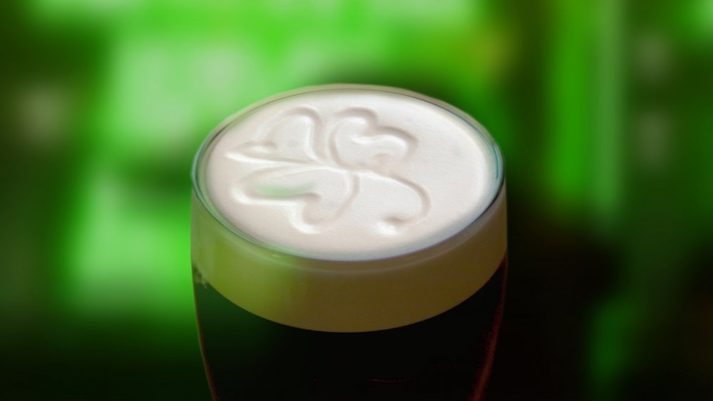 Pint of Guinness with a shamrock in the foam