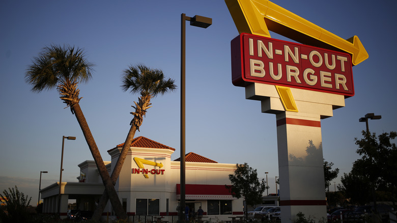 In-N-Out Burger with palm trees at dusk