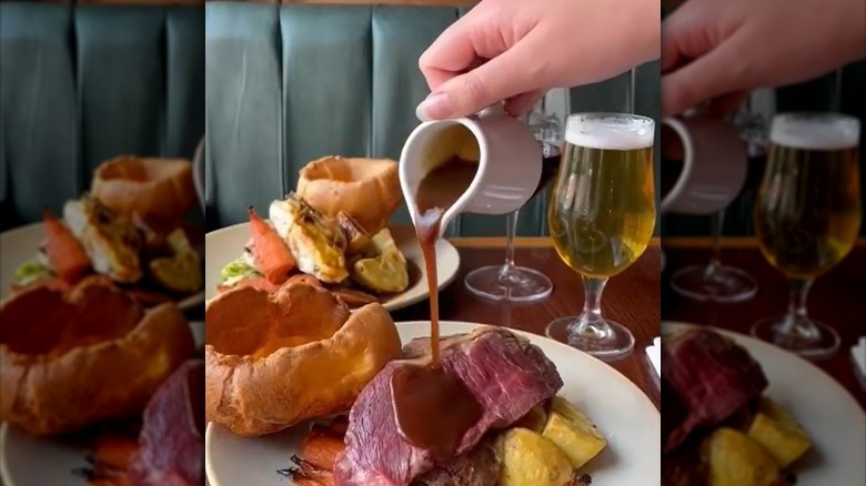 pouring gravy on sunday roast