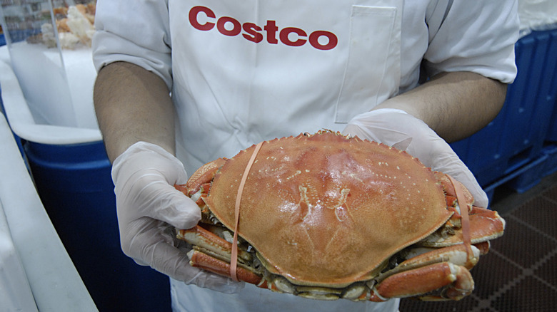 Costco employee holding crab
