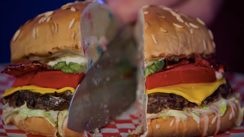 Cutting a burger cake