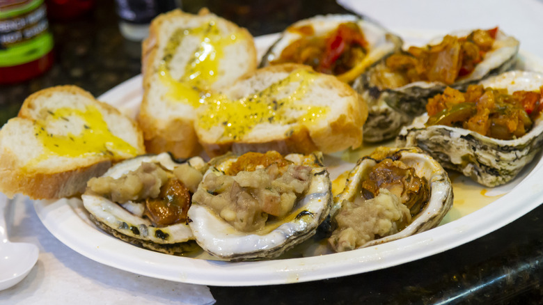 Paper plate with cajun-style oysters and bread