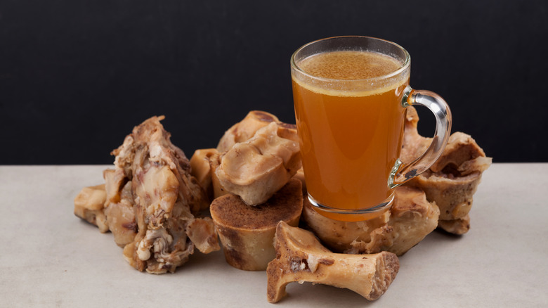 A cup of bone broth and beef bones