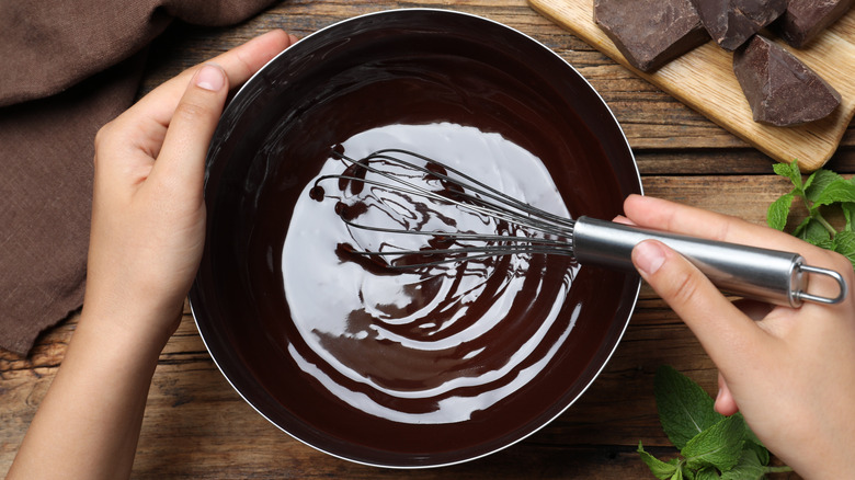 Person whisking melted chocolate