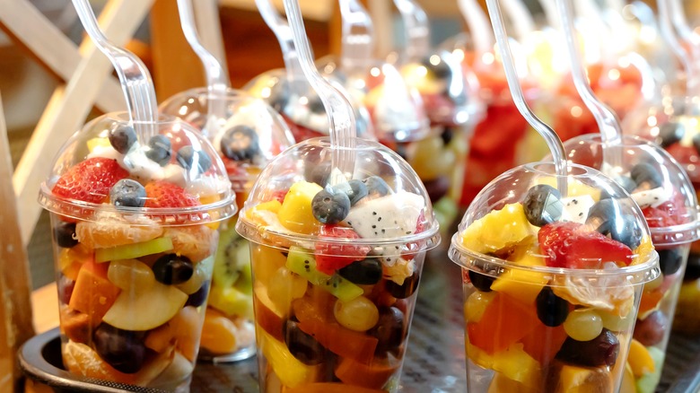 Sliced fruits in plastic cups
