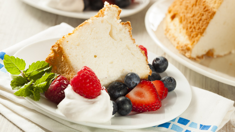 Slice of angel food cake with berries, whipped topping