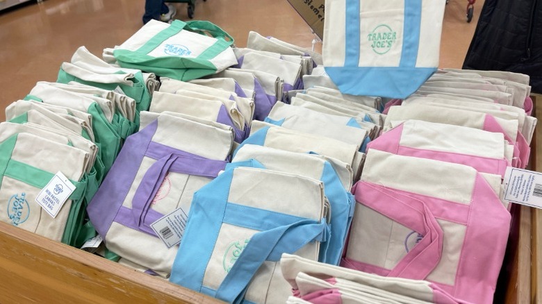 Trader Joe's pastel tote bags organized neatly in a wooden box