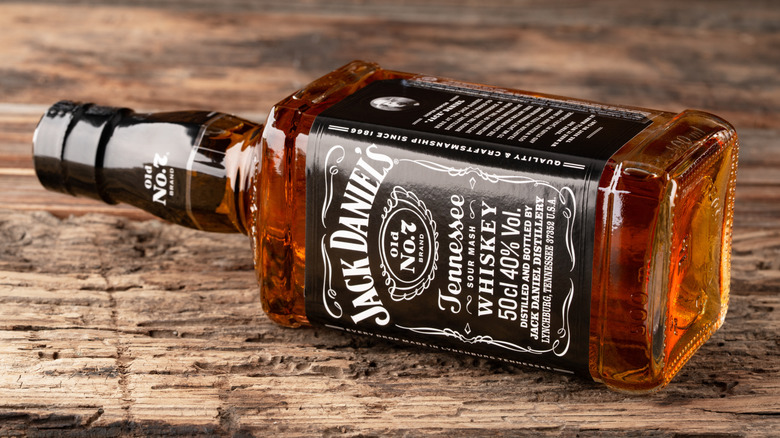 A bottle of Jack Daniels lying on its side.
